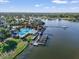 Scenic view of a community pool, lake with docks, clubhouse, and lush landscaping on a sunny day at 610 Winterside Dr, Apollo Beach, FL 33572