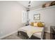 A cozy bedroom with a neutral palette features a decorative shelf, a window, and a comfortable bed at 610 Winterside Dr, Apollo Beach, FL 33572