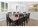 Elegant dining room with a large table, seating for eight, stylish light fixture, and plantation shutters at 610 Winterside Dr, Apollo Beach, FL 33572