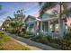 Charming coastal home featuring a manicured lawn, inviting porch, and beautiful landscaping at 610 Winterside Dr, Apollo Beach, FL 33572