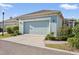 Detached garage shows great curb appeal with blue paint, updated lights, and tidy landscaping at 610 Winterside Dr, Apollo Beach, FL 33572