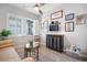 A cozy living room filled with stylish furniture, a dark wood cabinet, and bright natural light from the window at 610 Winterside Dr, Apollo Beach, FL 33572