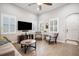 Open-concept living room with tile floors, plantation shutters, and comfortable seating arrangement at 610 Winterside Dr, Apollo Beach, FL 33572