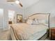Comfortable main bedroom featuring a decorative ceiling fan and an ensuite bathroom through the open doorway at 610 Winterside Dr, Apollo Beach, FL 33572