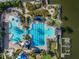 Aerial view of a luxurious community pool area with various pools, lounge chairs, and tropical landscaping at 610 Winterside Dr, Apollo Beach, FL 33572