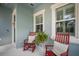 Inviting porch featuring rocking chairs, a fern, and serene ambiance for relaxation and enjoyment at 610 Winterside Dr, Apollo Beach, FL 33572