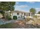 Well-manicured backyard featuring lush greenery, stone pathway, and an enclosed patio, perfect for relaxation and enjoyment at 708 Rutgers Pl, Sun City Center, FL 33573