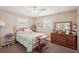 Bedroom with a bed, dresser, and two windows at 708 Rutgers Pl, Sun City Center, FL 33573