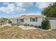 Attractive single-story home with a landscaped front yard and a cozy front porch area at 708 Rutgers Pl, Sun City Center, FL 33573