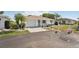 Inviting single-story home with a brick-paved driveway and a well-maintained front yard at 708 Rutgers Pl, Sun City Center, FL 33573