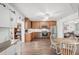 Bright kitchen with stainless steel appliances, wood cabinets, and an adjacent dining area at 708 Rutgers Pl, Sun City Center, FL 33573