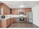 Spacious kitchen with stainless steel appliances, wood cabinets, and tile backsplash at 708 Rutgers Pl, Sun City Center, FL 33573