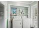 Efficient laundry area with washer, dryer, and extra storage at 708 Rutgers Pl, Sun City Center, FL 33573