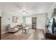 Cozy living room with natural light, wood-look floors, and comfortable seating at 708 Rutgers Pl, Sun City Center, FL 33573