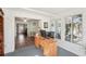 Bright office featuring natural light, wood desk, and seamless transition to dining area at 708 Rutgers Pl, Sun City Center, FL 33573
