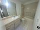 Bright bathroom with single vanity sink, tiled tub and shower at 7125 Silvermill Dr, Tampa, FL 33635