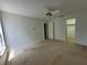 Bright bedroom with a ceiling fan, carpet flooring, and ample closet space at 7125 Silvermill Dr, Tampa, FL 33635