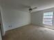 Bright bedroom featuring a ceiling fan and a sunlit window at 7125 Silvermill Dr, Tampa, FL 33635