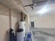 Garage interior featuring water heater and other utilities, showcasing the practical space for home maintenance at 7125 Silvermill Dr, Tampa, FL 33635
