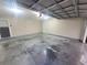 Spacious garage with concrete floor and overhead door, offering ample parking and storage space at 7125 Silvermill Dr, Tampa, FL 33635