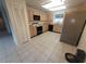 Functional kitchen with oak cabinets, black appliances, and a window for natural light at 7125 Silvermill Dr, Tampa, FL 33635