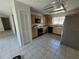 Tile floored kitchen with stainless steel appliances and light cabinets at 7125 Silvermill Dr, Tampa, FL 33635