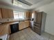 Kitchen featuring a stainless steel refrigerator and light wood cabinetry at 7125 Silvermill Dr, Tampa, FL 33635