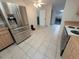 Modern stainless steel refrigerator complements this kitchen with tile floors and oak cabinets at 7125 Silvermill Dr, Tampa, FL 33635