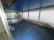 Enclosed patio with blue floor and white trim, offering a relaxing space with views of the outdoors at 7125 Silvermill Dr, Tampa, FL 33635
