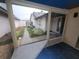 Enclosed patio providing a glimpse of the backyard with a lush lawn and cozy exterior views at 7125 Silvermill Dr, Tampa, FL 33635