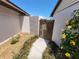 Charming walkway between homes featuring an ornate wooden gate and lush vegetation at 7125 Silvermill Dr, Tampa, FL 33635