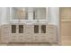 Bathroom vanity with double sinks, white cabinets, drawers and a large mirror at 739 1St Ct, Palm Harbor, FL 34684