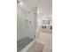 Modern bathroom featuring a glass-enclosed shower with decorative tile and vanity with storage at 739 1St Ct, Palm Harbor, FL 34684