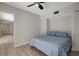 Bedroom featuring a bed with blue and white patterned bedding and a ceiling fan at 739 1St Ct, Palm Harbor, FL 34684