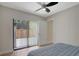 Bedroom featuring a bed with blue and white patterned bedding and access to a patio at 739 1St Ct, Palm Harbor, FL 34684