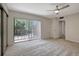 Large bedroom with slider to backyard, carpet flooring, and ensuite access at 739 1St Ct, Palm Harbor, FL 34684