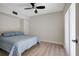 Bedroom featuring a bed with blue and white patterned bedding and a ceiling fan at 739 1St Ct, Palm Harbor, FL 34684