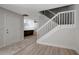 Inviting foyer with staircase, wood floors, and a view into the kitchen area at 739 1St Ct, Palm Harbor, FL 34684