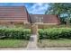 Charming front entrance to home featuring a walkway and a low fence and well-maintained landscaping at 739 1St Ct, Palm Harbor, FL 34684