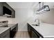 Kitchen with white countertops, modern appliances, and dark cabinets at 739 1St Ct, Palm Harbor, FL 34684