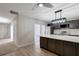 This modern kitchen offers a large island, stainless steel appliances, and a view of the stairs and backyard at 739 1St Ct, Palm Harbor, FL 34684