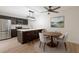 Bright eat-in kitchen features modern stainless steel appliances, white countertops, and stylish pendant lighting at 739 1St Ct, Palm Harbor, FL 34684