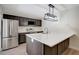 Modern kitchen with stainless steel appliances, sleek countertops, and stylish black cabinetry at 739 1St Ct, Palm Harbor, FL 34684