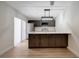 Open kitchen with a large island, stainless steel appliances, and plenty of countertop space at 739 1St Ct, Palm Harbor, FL 34684