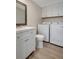 Well-equipped laundry area features a modern vanity, ample cabinet space and brand-new washer and dryer at 739 1St Ct, Palm Harbor, FL 34684