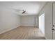 Spacious living room featuring wood floors, neutral paint, and a modern ceiling fan at 739 1St Ct, Palm Harbor, FL 34684