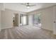 Bright bedroom with sliding glass doors, neutral carpet, and ensuite bathroom access at 739 1St Ct, Palm Harbor, FL 34684