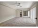Spacious main bedroom with neutral carpet, sliding doors, and ensuite bathroom access at 739 1St Ct, Palm Harbor, FL 34684