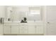 Elegant bathroom featuring double sinks, a marble countertop, and ample cabinet space at 7541 E 116Th St, Palmetto, FL 34221