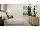 Inviting bedroom with natural light, wooden dresser, mirror, and indoor potted plant at 7541 E 116Th St, Palmetto, FL 34221
